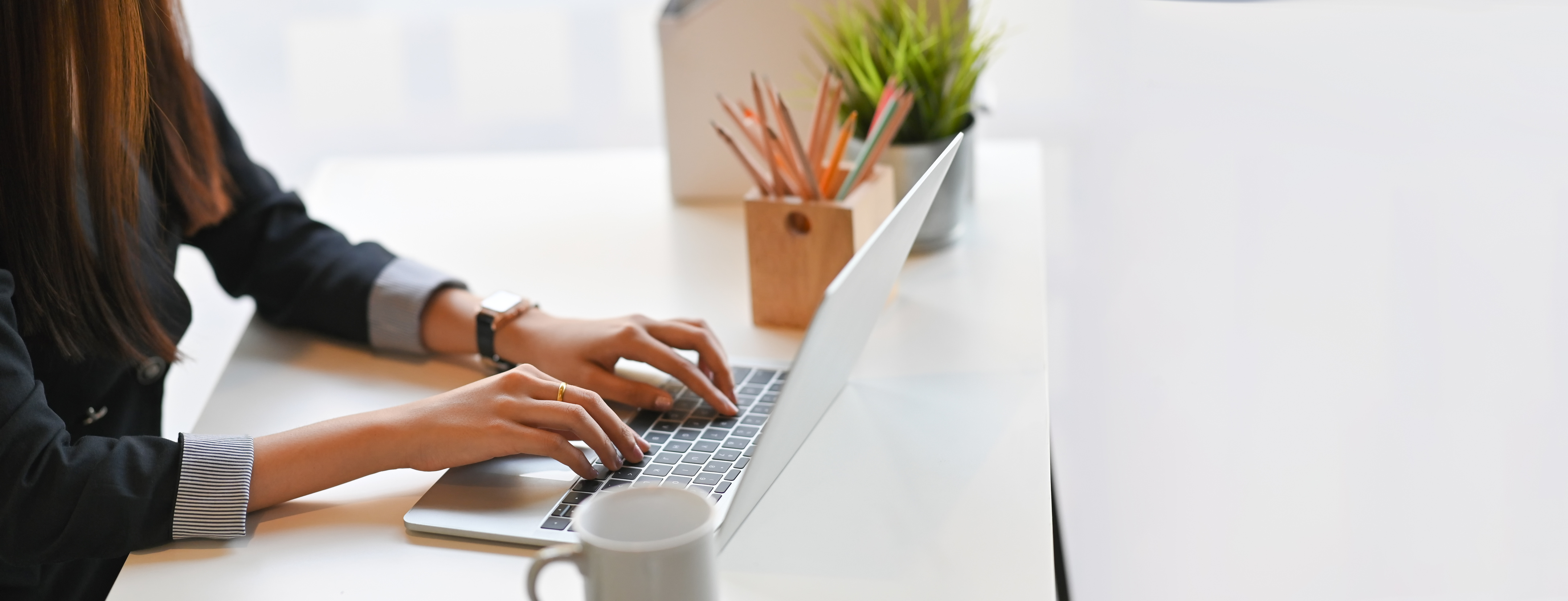 Businesswoman Typing on Laptop